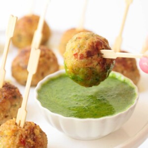 Vertical picture of Vietnamese Chicken Meatballs on toothpicks with dipping sauce