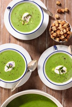Overhead picture of Fresh Spinach Soup in small blue and white bowls with croutons