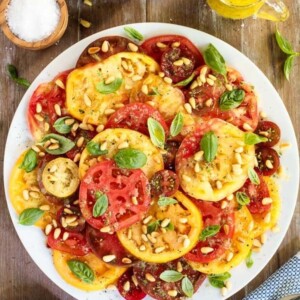 Overhead picture of summer tomato salad on a wooden table