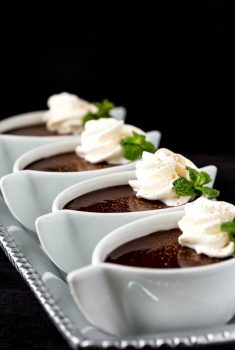 Vertical picture of Blender Chocolate Pots de Crème in small white dishes garnished with whipped cream and mint