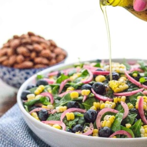 Vertical picture of Blueberry Spinach Salad in a white bowl