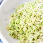 Vertical close up picture of Broccoli Parmesan Quinoa in a white bowl
