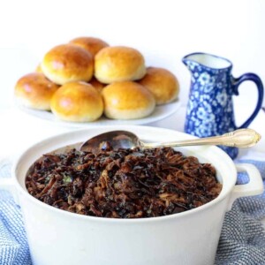 Brown Sugar Balsamic Pulled Pork in a white pot with buns in the background
