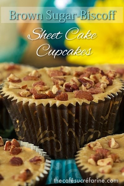 Closeup photo of a Brown Sugar Biscoff Sheet Cake Cupcake with other cupcakes in the foreground and background.