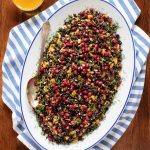 Overhead picture of butternut squash and black rice salad on a white oval platter