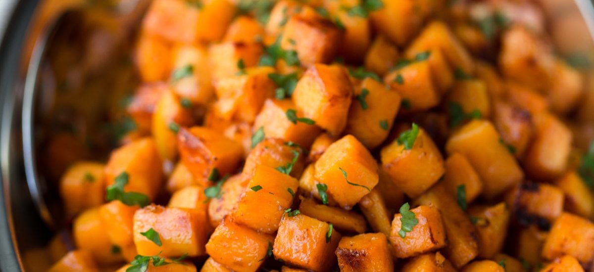 Photo of a pewter serving dish of Caramelized Sweet Potatoes.