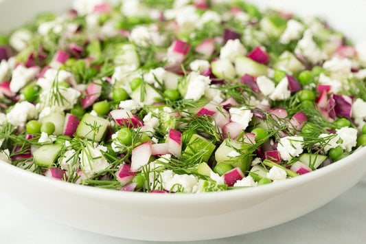 Side photo of a white dish of Chopped Cucumber Dill Salad