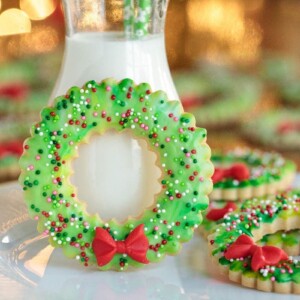 Christmas wreath shortbread cookies and a glass of milk.