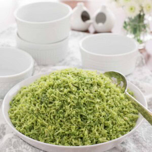 Cilantro Rice (Arroz Verde) 1 cup fresh baby spinach, tightly packed ½ cup cilantro, tightly packed 1 cup low sodium chicken broth 1 cup milk 1 teaspoon kosher salt 2 tablespoon butter 1 tablespoon extra virgin olive oil 1 ½ cups basmati rice ¼ cup onion, finely chopped 1 clove garlic, finely minced This beautiful-hued Cilantro Rice is a delicious alternative to plain rice and will receive wow reviews every time you serve it! 1. Place the spinach, cilantro, chicken broth, milk and salt into a blender container and blend until pureed. 2. In a medium saucepan heat olive oil and butter until butter is melted. Add the rice and sauté, stirring about every 30 seconds, until light golden, 3 to 4 minutes. 3. Add the onion and garlic and cook 1 minute, stirring frequently. 4. Add the spinach/cilantro mixture, stir well and and bring to a boil. Cover the pan, turn heat to very low and cook for 20 minutes. 5. Stir the rice gently (to avoid crushing) with a fork. Cover and continue cooking on very low heat another 5 minutes. 6. Take pan off heat and let rice steam in the covered pot for 10 minutes. Fluff with a fork and serve.
