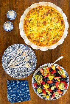 Vertical overhead picture of classic Quiche Lorraine with fresh fruit