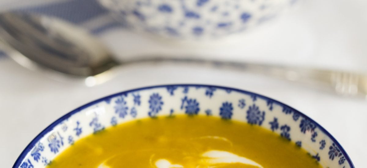 Photo of two blue and white patterned bowls of Carrot Coriander Soup.