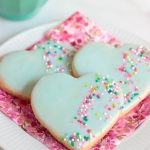 Vertical photo of Valentine Shortbread Heart Cookies on a pink napkin.