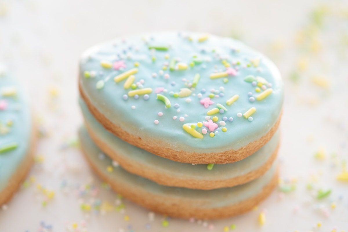 Horizontal extreme closeup photo of a stack of decorated Spring Shortbread Cookies.