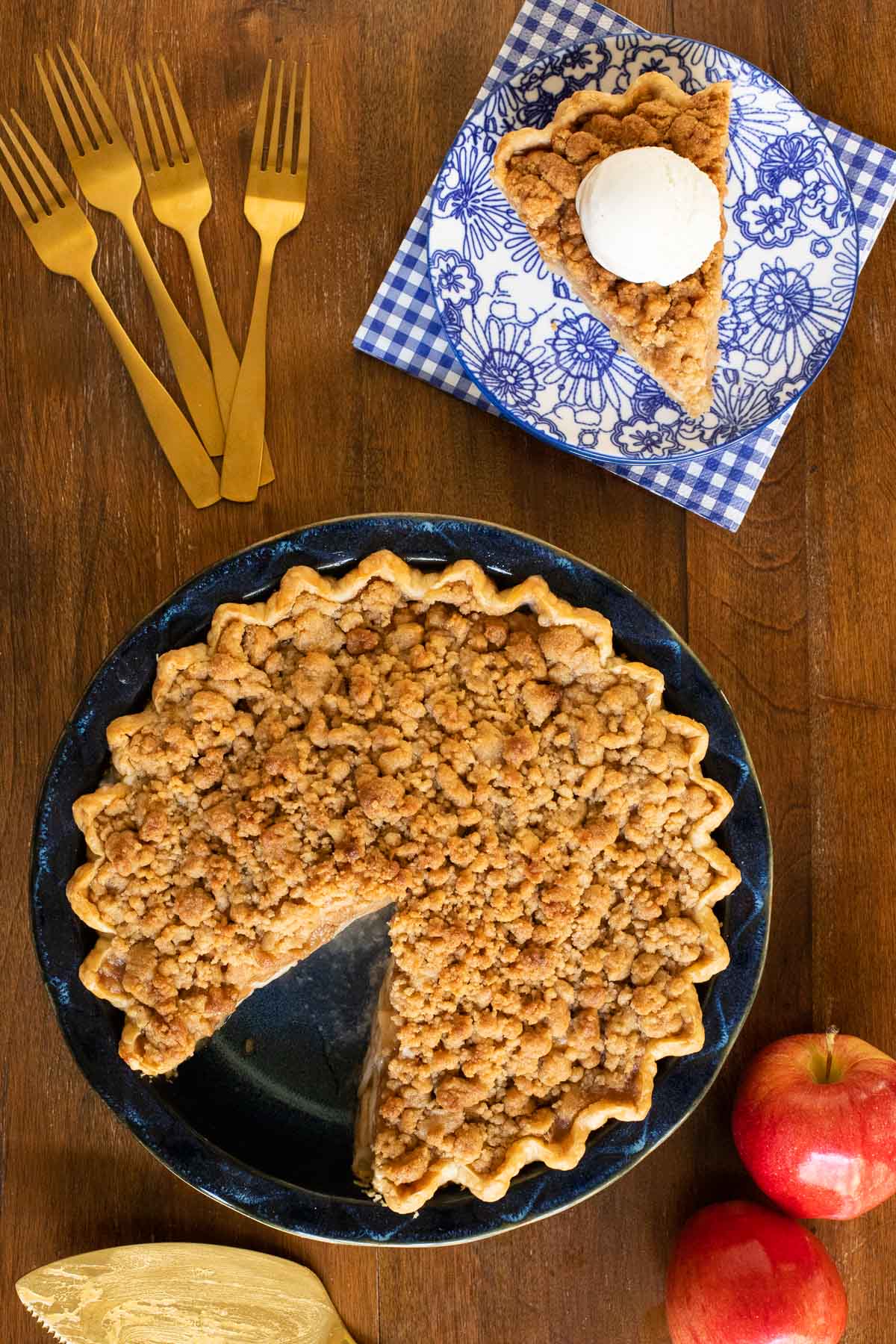 Overhead vertical photo of an Annie's Easy Apple Pie in a navy pie pan on a wood table.