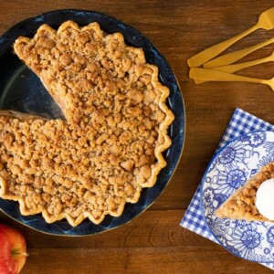 Horizontal overhead photo of an Annie's Easy Apple Pie in a porcelain pie pan on a wood table.