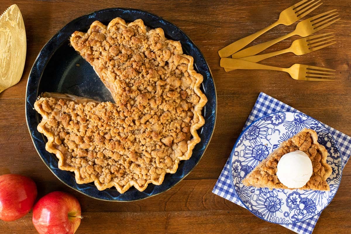 Horizontal overhead photo of an Annie's Easy Apple Pie in a porcelain pie pan on a wood table.