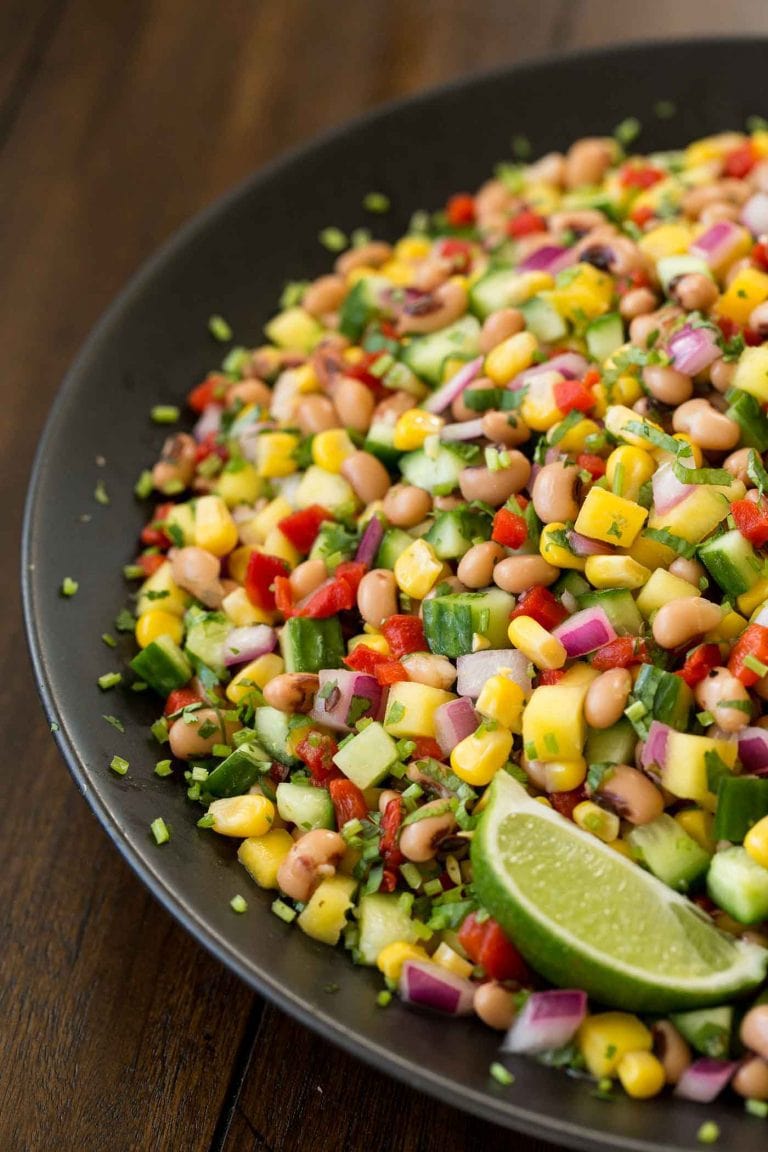 Vertical close up picture of Easy Black-Eye Pea Salad on a black plate