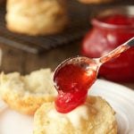 Spooning Strawberry jam onto Ridiculously Easy Buttermilk Biscuits - thecafesucrefarine.com