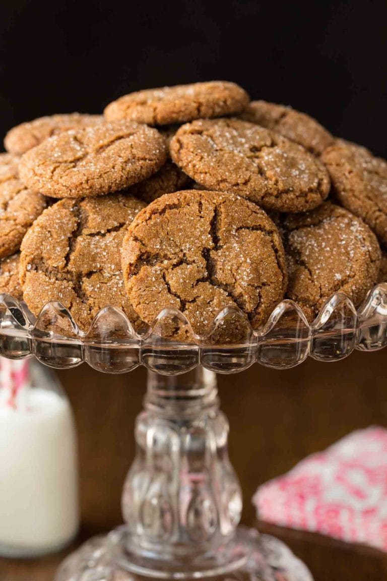 Vertical picture of ginger molasses cookies piled on a cake stand