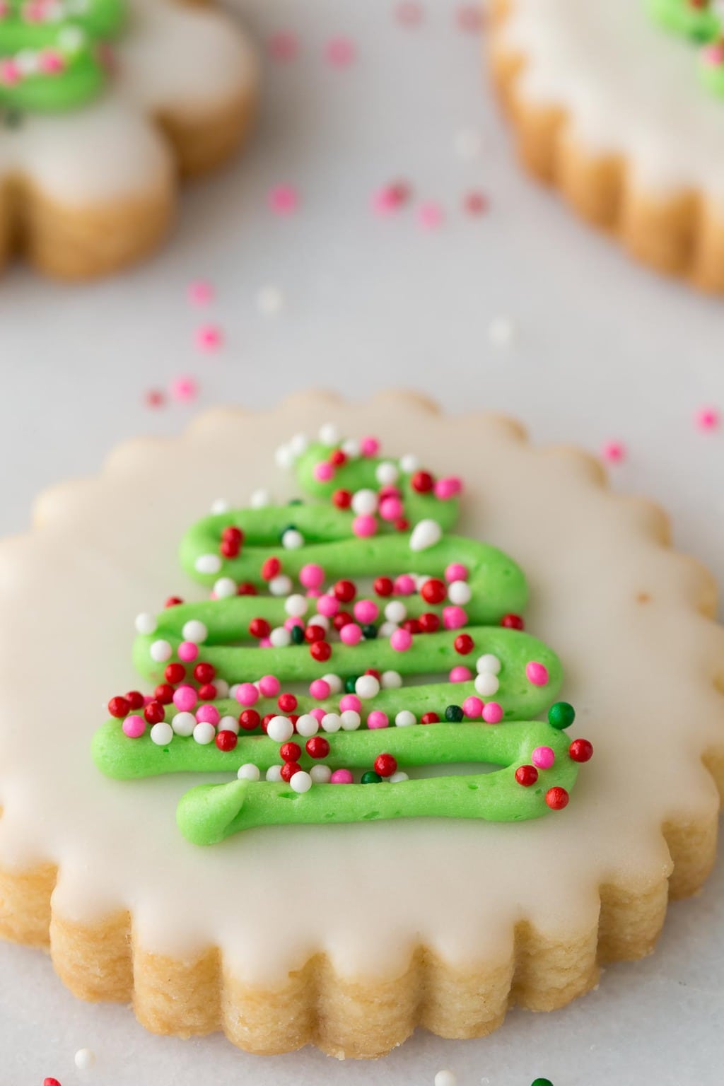 Closeup photo of finished Christmas Shortbread Cookies on a white marble slab.