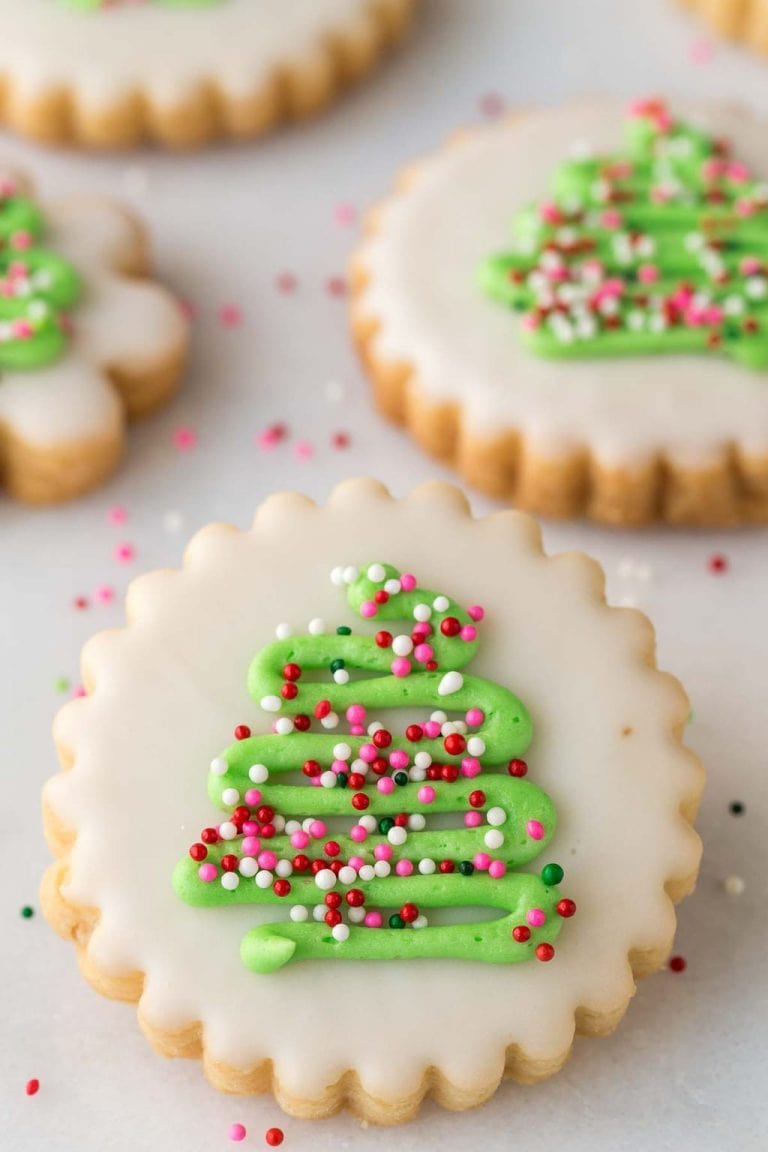 Overhead picture of decorated christmas cookies on a white background