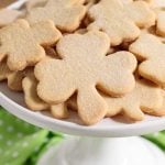Vertical picture of shamrock shortbread cookies on a white cake stand