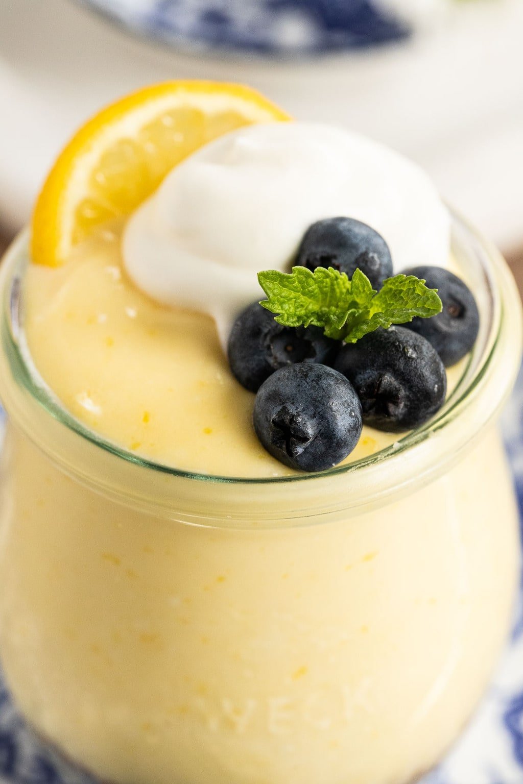 Closeup photo of the top of a glass jar filled with Easy Lemon Curd Mousse.