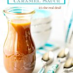 Vertical closeup photo of a glass carafe filled with Easy Microwave Caramel Sauce and surrounded by turquoise trimmed bowls and utensils.