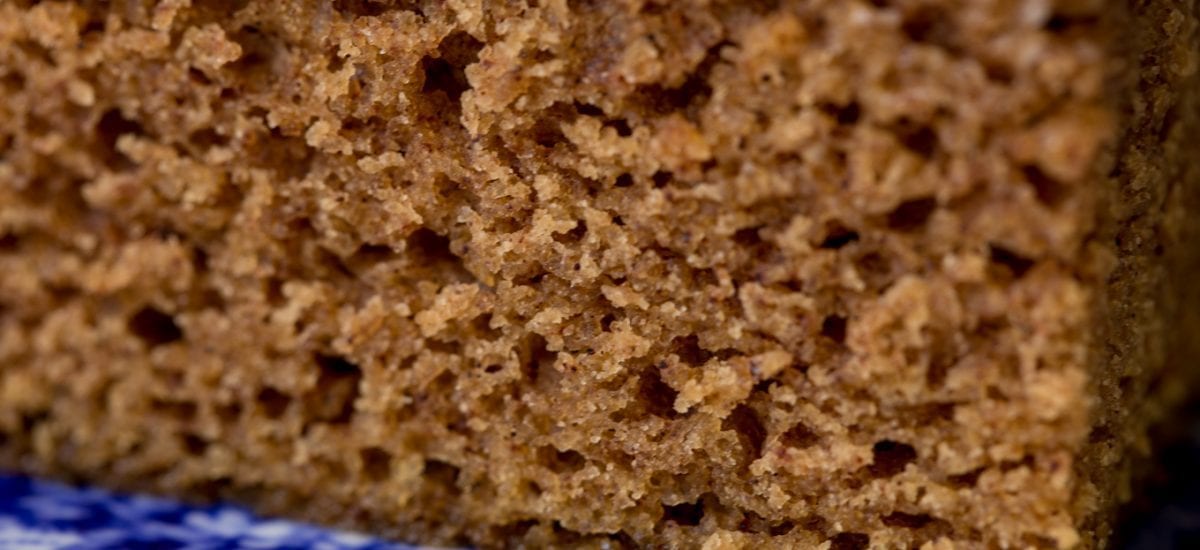 Ultra closeup of the crumb of a piece of Easy Gingerbread Cake with Vanilla Bean Icing.