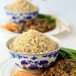Easy Orange Chicken with Brown Rice - a super delicious dinner you can have on the table in no time flat. A few secret ingredients make the chicken incredibly tender!