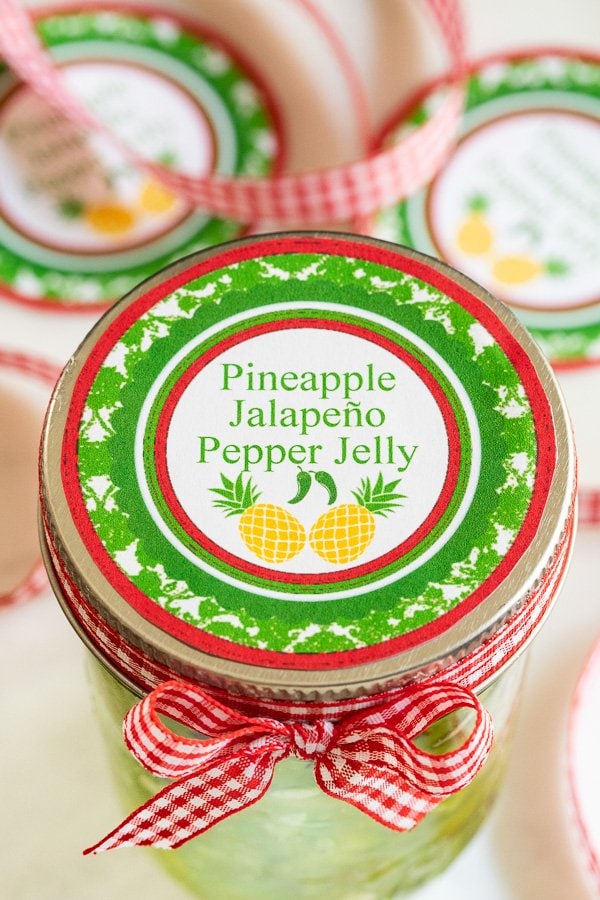 Pineapple Jalapeno Pepper Jelly in a glass jar with printed labels.