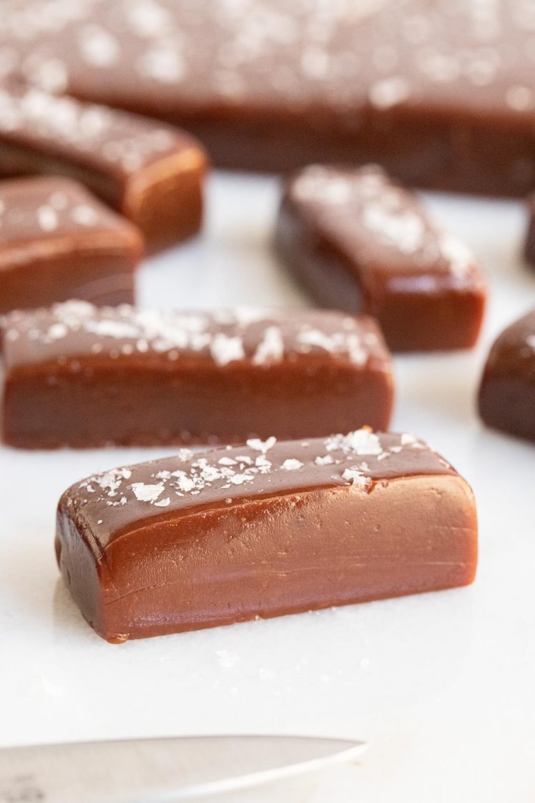 Vertical close up picture of easy Salted Chocolate Caramels on parchment