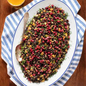 Overhead picture of black rice and butternut squash salad on a white oval platter