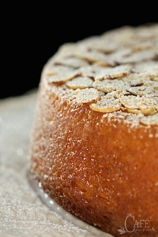 Close up vertical photo of the side and top of a French Almond Cake.