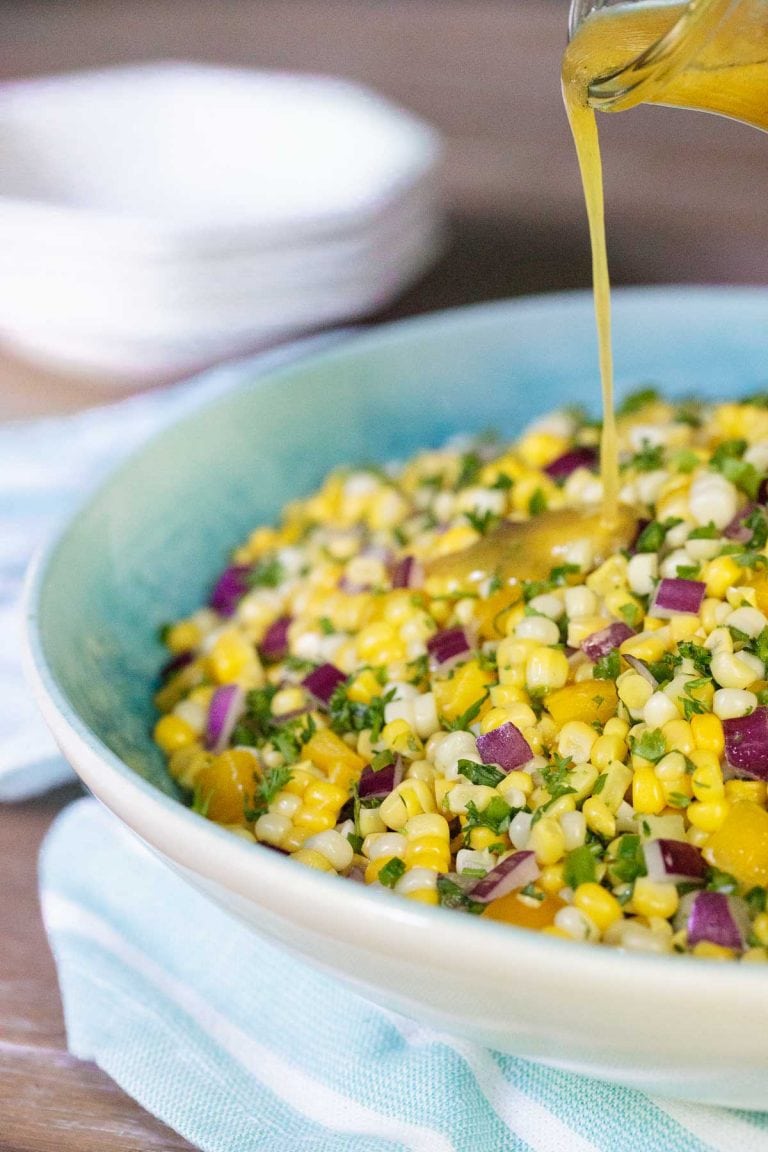 Fresh corn salad in a blue and white bowl.