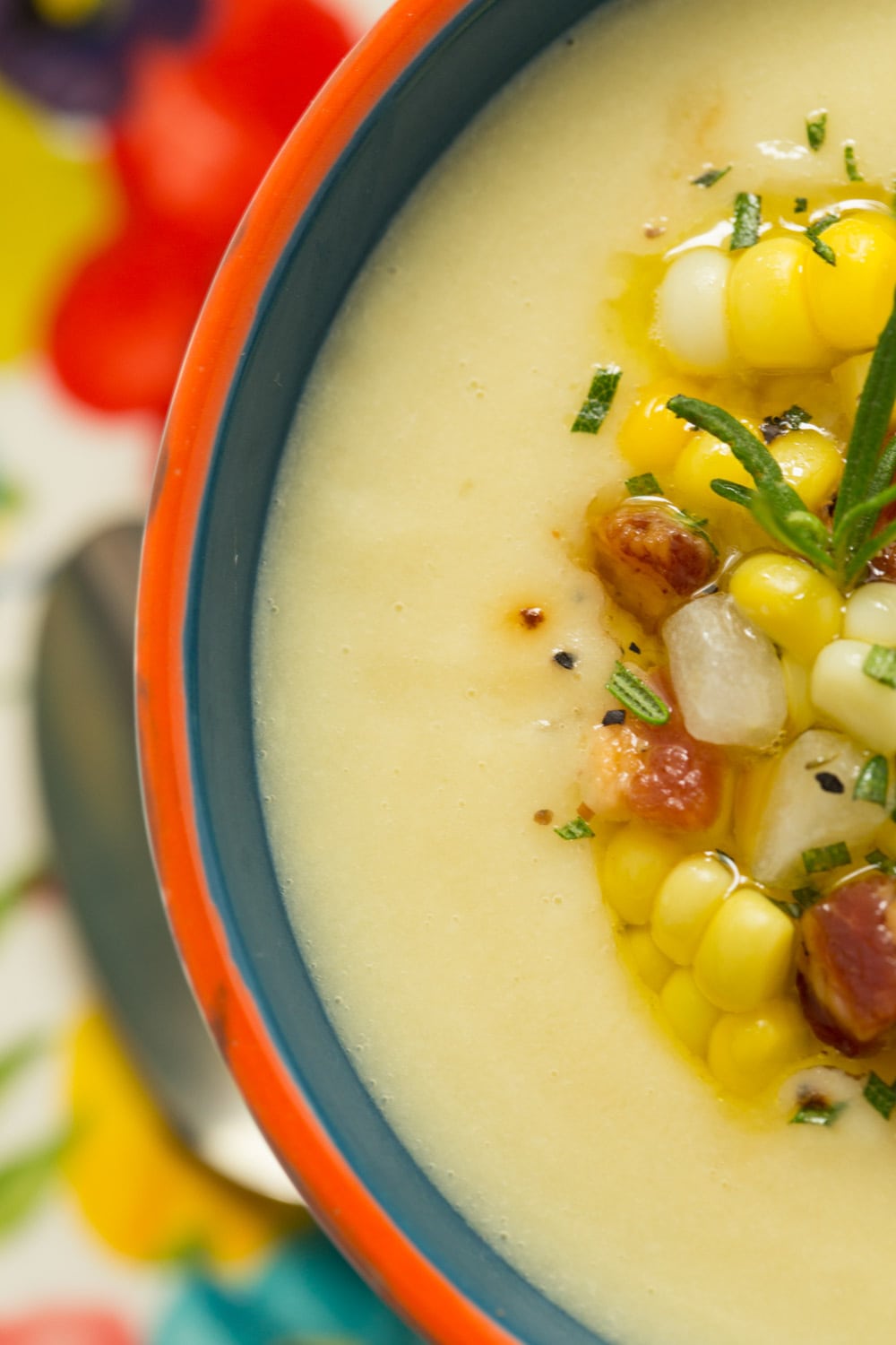 Ultra closeup photo of a bowl of Fresh Corn Soup in a multicolored decorative soup cup.