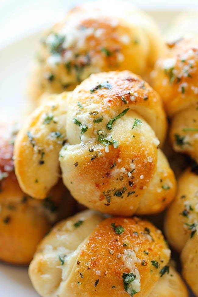 Closeup photo of a pile of Easy Garlic Parmesan Knots from "19 Delicious Thanksgiving Sides" blog post.