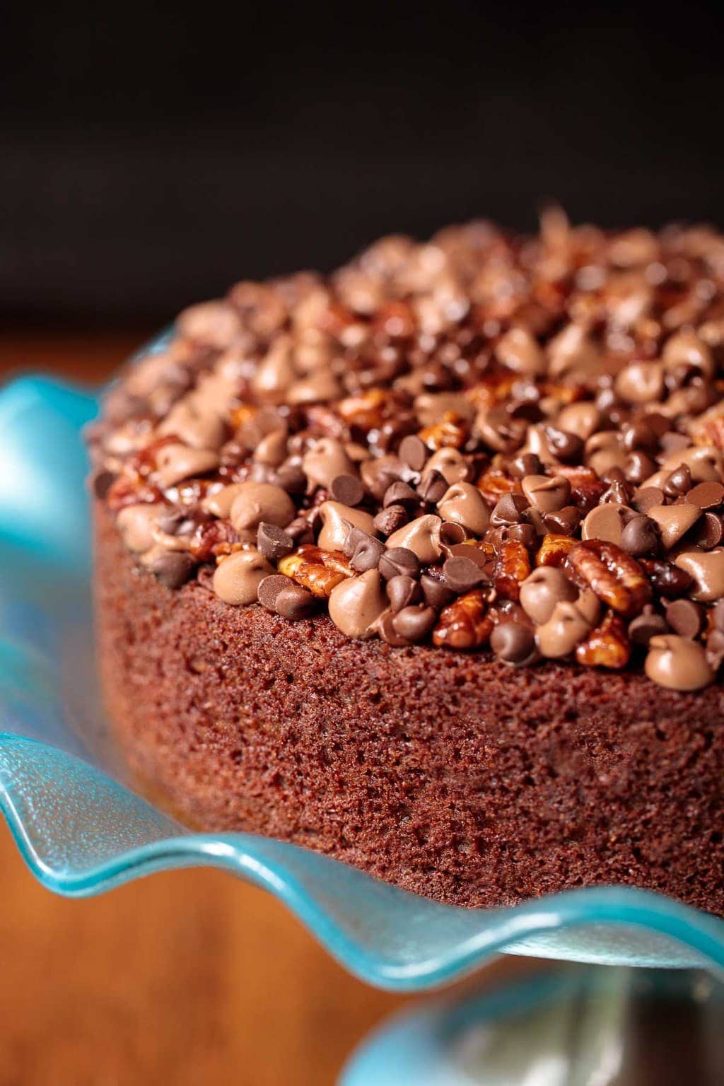 Photo of an Easy Chocolate Yogurt Cake on a turquoise serving cake stand.