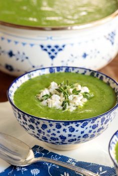 Vertical photo of Ham and Fresh Pea Soup in a blue and white patterned bowl.