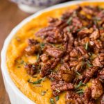 Vertical close up picture of healthy sweet potato casserole in a white dish