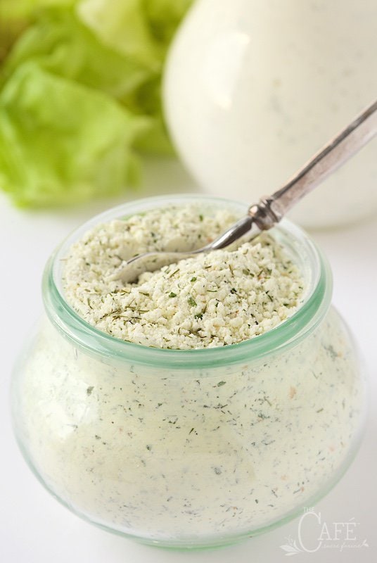 Vertical photo of Homemade Buttermilk Ranch Dressing Mix in a Weck glass jar with salad making ingredients in the background.