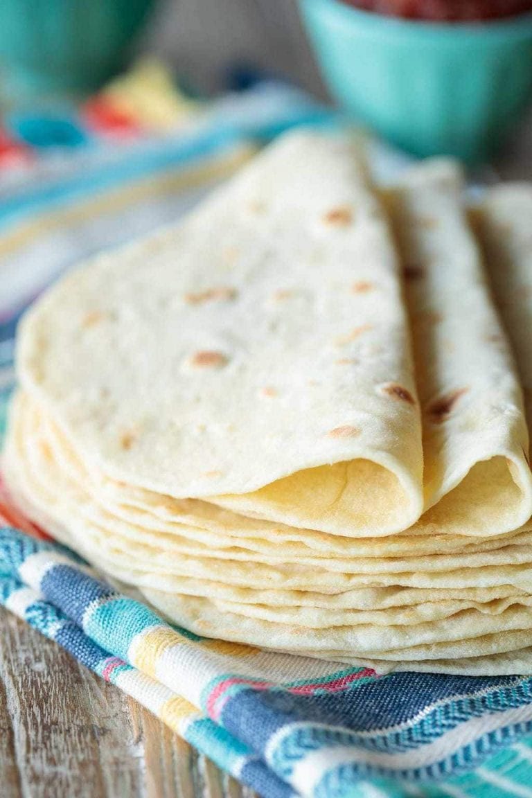 Close up vertical picture of homemade flour tortillas in a stack