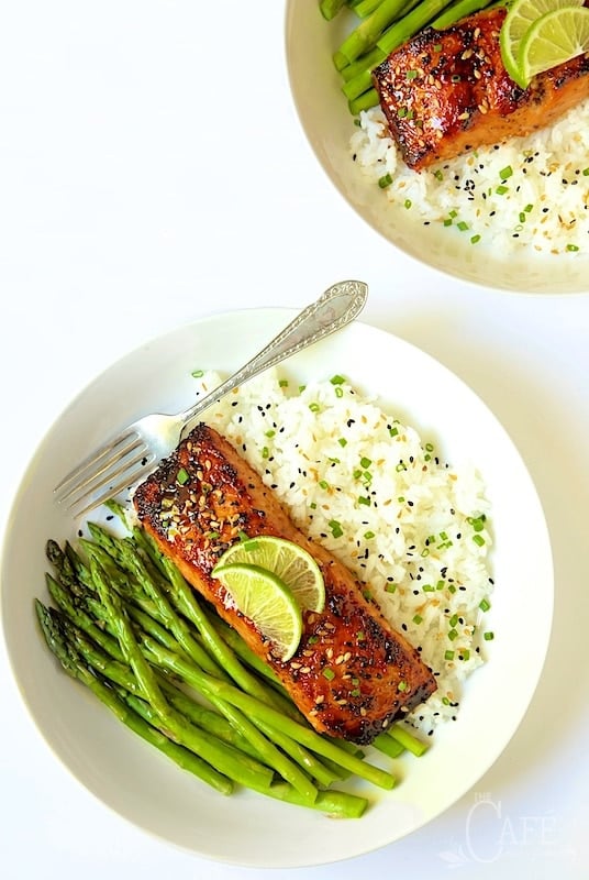 Vertical overhead photo of Honey Bourbon Glazed Salmon in a white serving bowl with rice and asparagus spears.