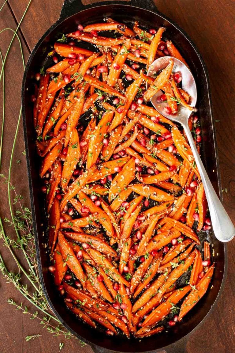 Overhead picture of Honey Maple Roasted Carrots in an oval cast iron skillet