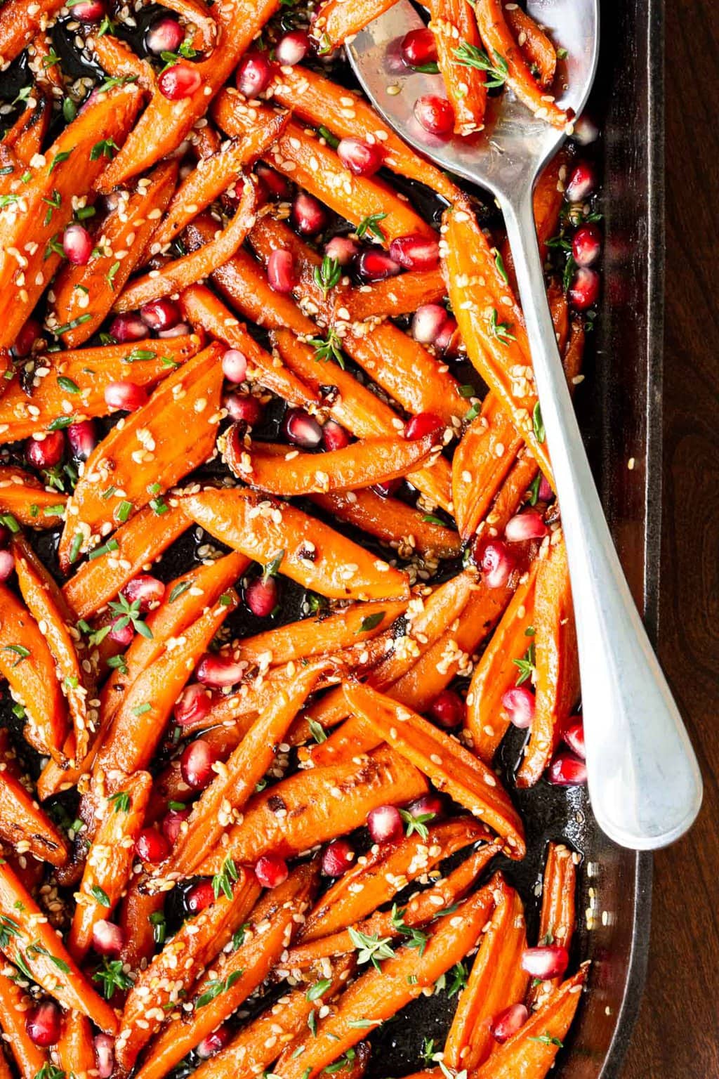 Closeup overhead vertical photo of Honey Roasted Carrots with Pomegranates.