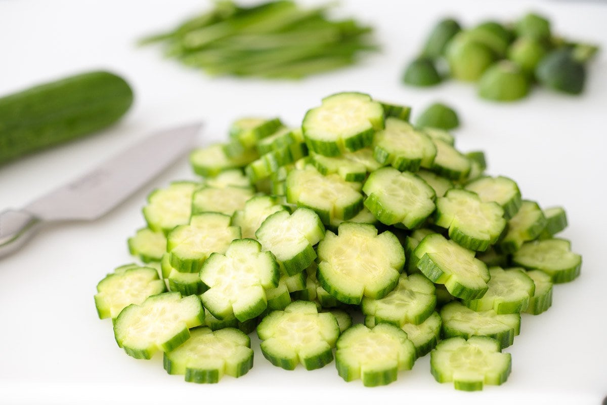 Photo of a pile of decorative cucumbers demonstrating How to Make Cucumber Flowers.