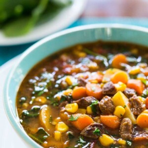 Vertical picture of Instant Pot Italian Vegetable Beef Soup in a white bowl