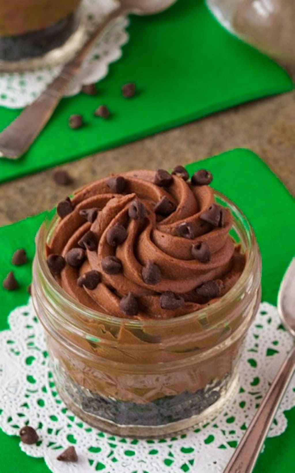 Vertical closeup photo of Irish Chocolate Cheesecake in a small mason jar.
