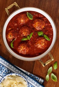 Overhead picture of Italian Chicken Meatballs with Marinara in a large pot on a wooden table