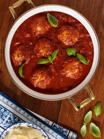 Overhead picture of Italian Chicken Meatballs with Marinara in a large pot on a wooden table